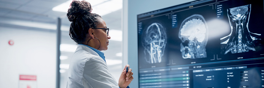 A medical professional looking at images of a person's nervous system.