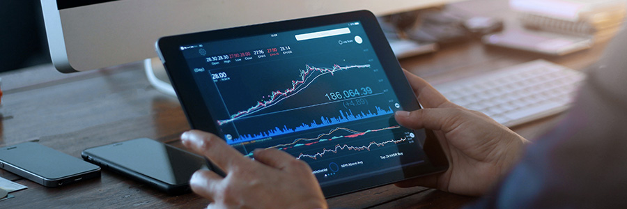 A closeup of a tablet computer showing stock data charts