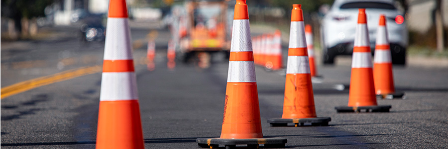 Several pylons on a road that is under constructions