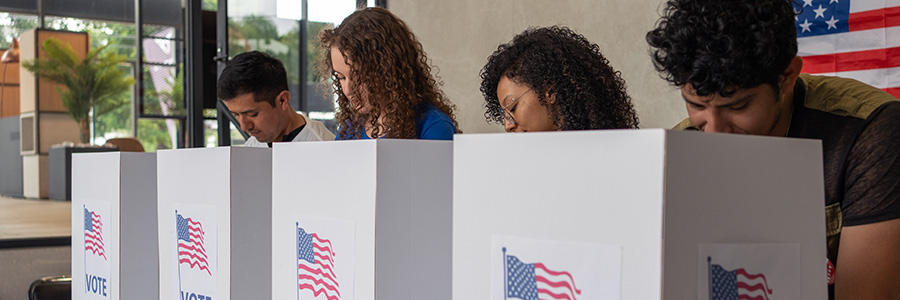 A row of young people voting in an election.