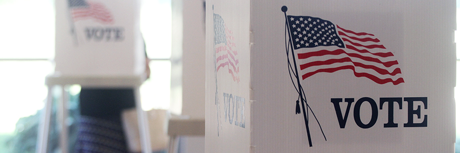 A U.S. election polling station with people receiving their ballots to vote.