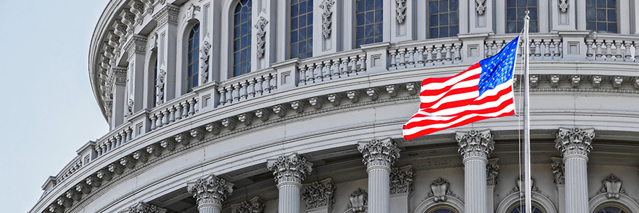 The American flag flying in front of the U.S. Capitol building in Washington, D.C.