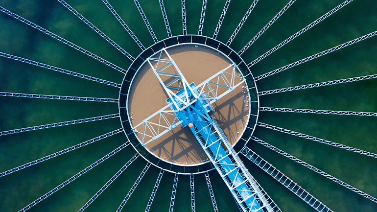 Top-down view of a pool of water in a water treatment plant.